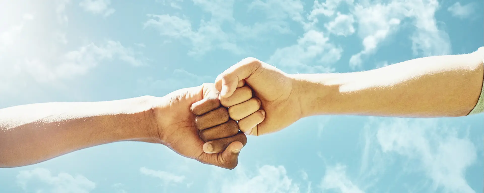 Two people fist bumping to show good sportsmanship during a scavenger hunt.